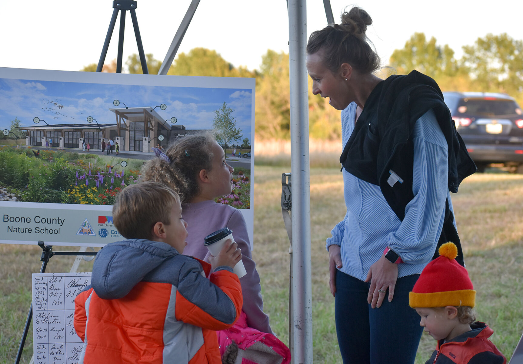 Elizabeth Simmons looks at a map with her children